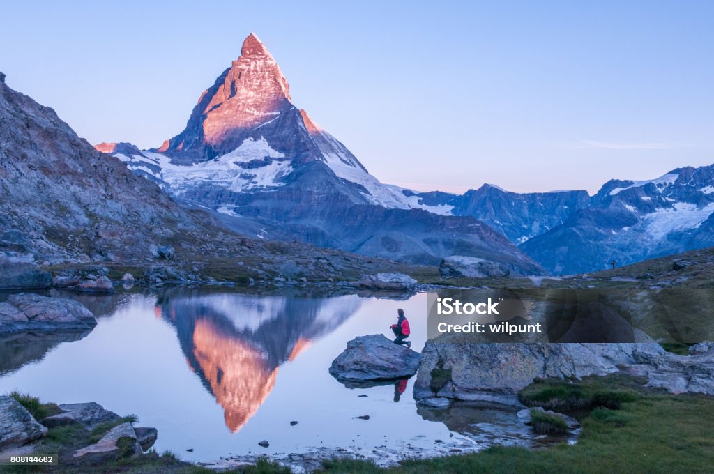 The Matterhorn at dawn, reflected in a lake below Zermatt
